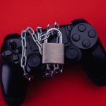 Gamepad z kłódką, koncepcja uzależnienia od gier.