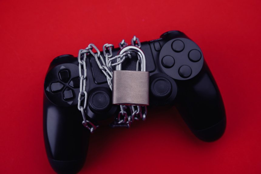 Gamepad z kłódką, koncepcja uzależnienia od gier.