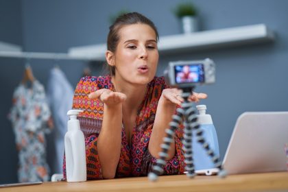 Zdjęcie przedstawiające influencerkę zajmującą się urodą, która nagrywa samouczek na żywo
