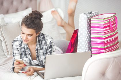 Młoda atrakcyjna kobieta robi zakupy online w domu
