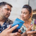 para siedząca w restauracji pokazuje jej telefon podczas rozmowy