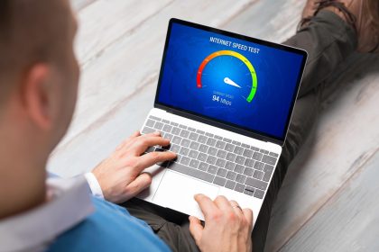Mężczyzna sprawdzający prędkość połączenia internetowego na laptopie
