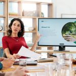 Woman talking and meeting for climate change in office about us and ideas of environment solution People explaining and brainstorming with proposal documents eco friendly information and screen