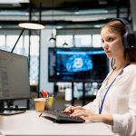 Female engineer listening music at work adjusting deep learning algorithms parameters to automate