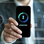 Man Holding Smartphone Displaying Software Update Progress
