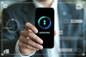 Man Holding Smartphone Displaying Software Update Progress