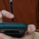 Man Tapping Smartphone Screen In Mobile App Interaction Checking Notification And Communication Mes