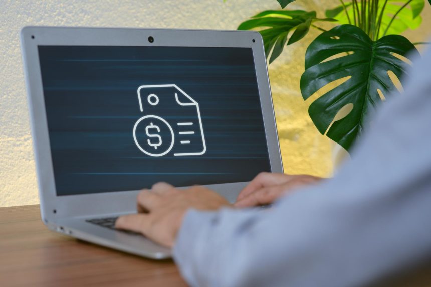 Person Typing on Laptop with Finance Document and Dollar Symbol Icon