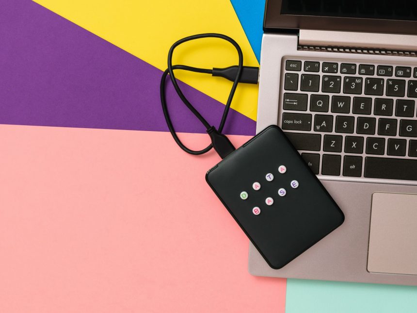 Zewnętrzna dysk twardy z etykietą bazy danych podłączonej do laptopa
