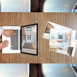 Przycięta ręka człowieka używającego laptopa na stole